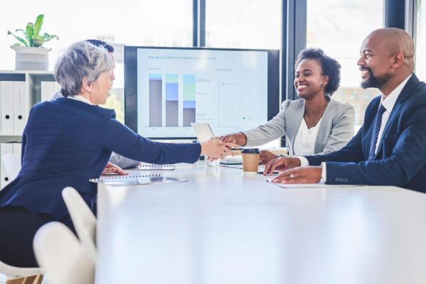 Diverse African business executives discussing corporate strategy during an executive leadership meeting in a modern boardroom, representing executive search and leadership recruitment in Africa.